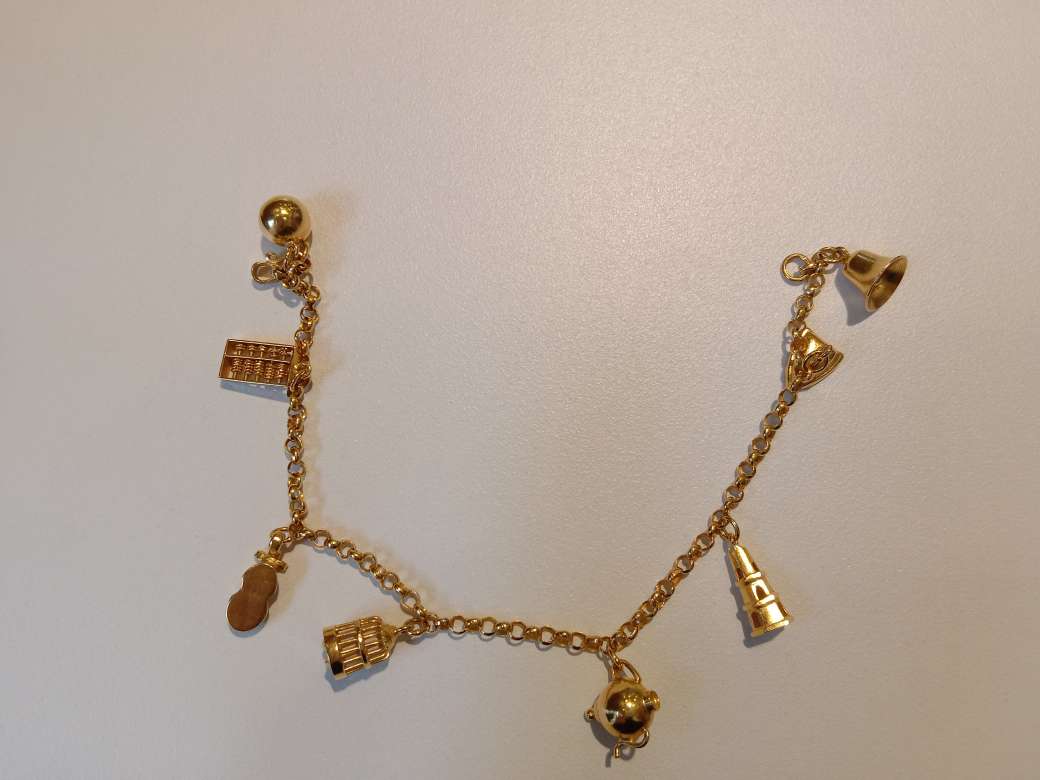 K19 gold bracelet with charms