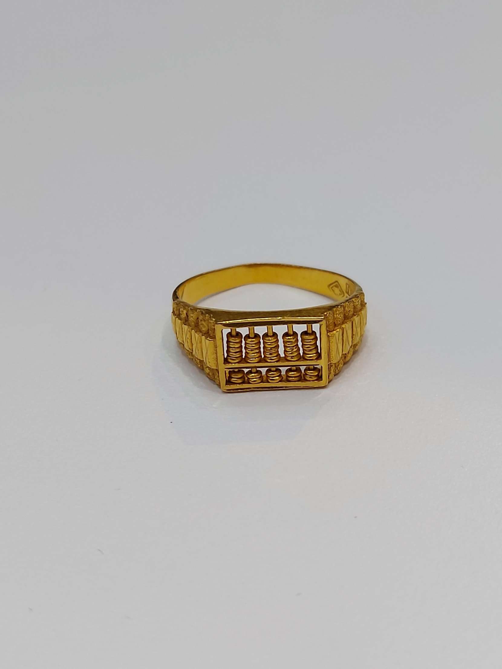 gold ring with abacus design